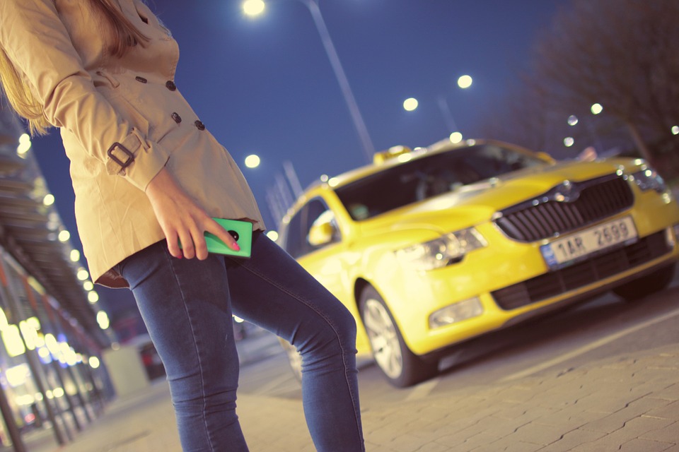 woman waiting for taxi near road